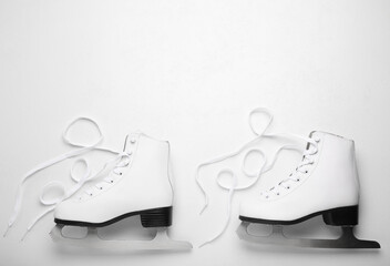 Wall Mural - pair of ice skates on white background, top view. space for text