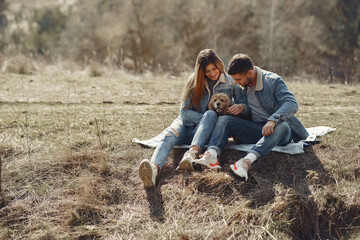 Woman in a jeans clothes. Couple in a spring forest. People with a cute dog.