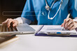 © NINENII - Doctor working with a laptop search for medical information at the hospital office during the day.
