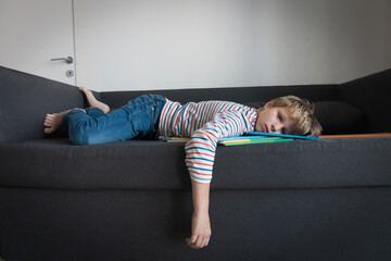 Wall Mural - sad boy tired and stressed of learning, doing homework