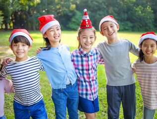 Wall Mural - Group of happy kids having fun in christmas party