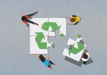 Team Finishing Recycling Symbol Jigsaw Puzzle With Missing Piece
