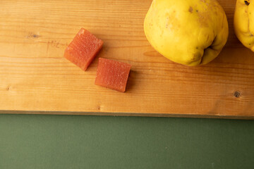 Wall Mural - quince fruit on green background