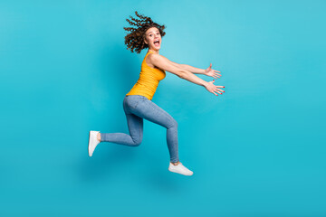 Wall Mural - Full length photo of crazy lady jump high rush season shopper wear casual clothes isolated blue color background