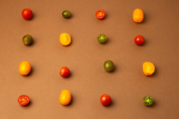 Wall Mural - various kinds of mini tomatoes on brown background