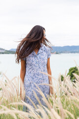 Portrait of sensetive romantic woman wearing cute blue dress on wheat field. 