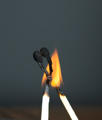 two matchstick lit on black background