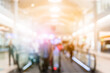© Chan2545 - Blurred background with bokeh light in empty airport due to coronavirus covid new normal rule shop store area runway escalator with travel passenger fly flight travel walking in hallway in terminal