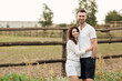 © Andriy Medvediuk - happy young man and woman having fun outdoors on a warm summer day. couple is hugging in the park near wooden fence