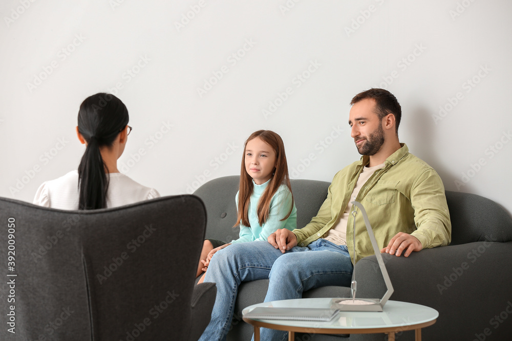 Father with little daughter in psychologist's office