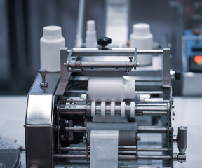 Poster - White bottle on labeling machine in pharmaceutical industrial