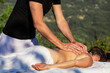 © Albert - Massage therapist massaging patient's back.