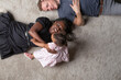 © Cavan Images - A young interracial couple playing with their young daughter