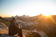 © Cavan Images - Side view of mountaineer watching sunset from high mountain pass.