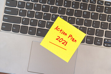Wall Mural - Action plan 2021 on yellow adhesive yellow paper note on top of laptop