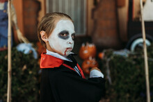 Young Boy Dressed As Dracula Posing In Costume At Halloween