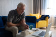 © Cavan Images - Senior man speaking with online doctor