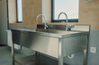 © Doralin - Industrial stainless steel sink in bathroom of an workshop