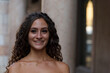 © Roza_Sean - Close-up of young girl with brown curly hair. Outdoor photo in the city at daytime.