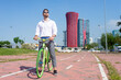 © Cavan Images - Young bearded man with sunglasses standing with bike outdoors