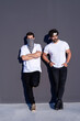 © Cavan Images - Two young urban man leaning on wall in cool attitude