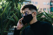 © Cavan Images - boy with sunglasses and mask calls on the phone