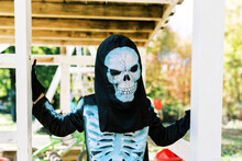 Little Boy Wearing A Skeleton Halloween Costume