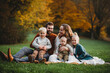 © Cavan Images - Beautiful family in a park smiling on an Autumn day