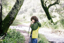 Boy Eating Apple By River Forest