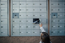 Child Unlocks And Opens Door To Cluster Mailbox Unit