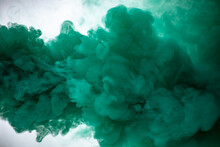 Green Smoke Bomb Exploding Against White Background