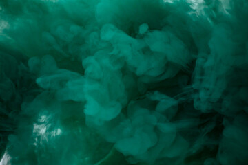 Green smoke bomb exploding against white background