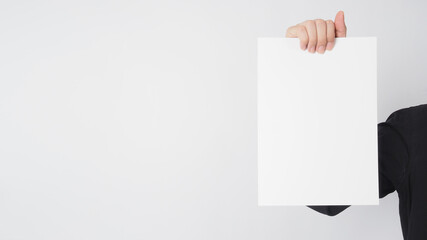 Male asian wear black shirt and hand is holding blank paper on white background.Empty space for text.