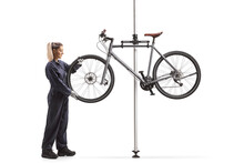 Female Bike Mechanic Removing A Bicycle Wheel