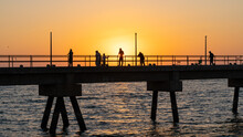 Pier With Fishermen At Sunset On Masirah Island In Oman