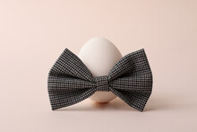 Easter Egg With Bow Tie On The Trendy Pastel Background.Minimal Concept.Holiday Background.