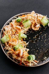 Wall Mural - Asian vegetable salad with shrimp on a black background