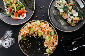 Wall Mural - Asian vegetable salad with shrimp on a black background