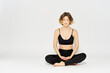 © SHOTPRIME STUDIO - Yoga asana woman crossed legs meditation light background room