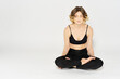 © SHOTPRIME STUDIO - Woman in leggings meditate in a light room with her legs crossed yoga asana