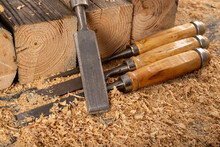 Wood Chisels Placed On Sawdust. Carpentry Accessories In The Workshop.