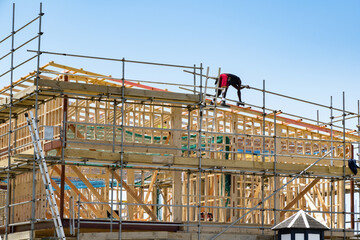 Sticker - AUCKLAND, NEW ZEALAND - Dec 04, 2019: Construction site with wooden frame and worker on roof