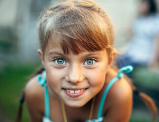 Wall Mural - Close-up portrait of an emotional little girl.