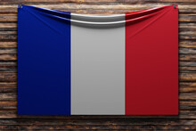 3D Illustration Of The National   Fabric Flag Of France  Nailed On A Wooden Wall .Country Symbol.
