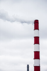 steam smoke from an industrial red-white pipe