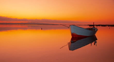 Poster - Boat in the water. Fishing boat in the calm waters of the pond of santa caterina in southern sardinia
