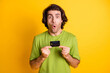 © deagreez - Portrait photo of shocked man demonstrating plastic debit card staring isolated on vivid yellow color background