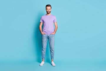 Poster - Full size photo of young handsome happy smile man hands in pocket isolated over blue color background