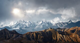 Fototapeta Góry - Panoramic view of the scenic landscape of snowy mountains and dramatic clouds