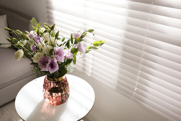 Canvas Print - Bouquet of beautiful Eustoma flowers on table in room. Space for text